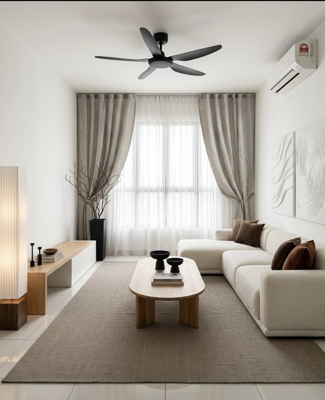 Japandi living room in a KL rental condo — low oak sofa, paper-shade floor lamp and warm neutral walls