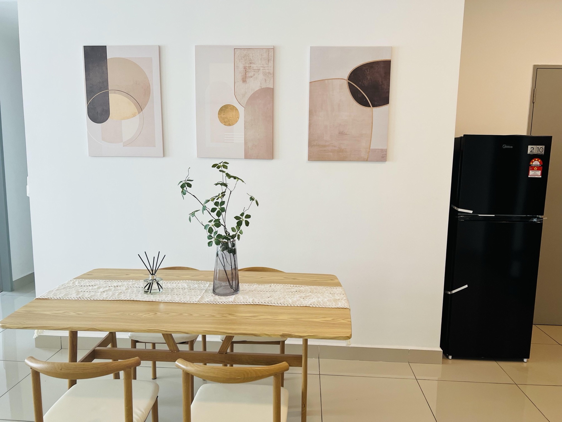 Dining area with solid oak table, wishbone chairs and three abstract canvases