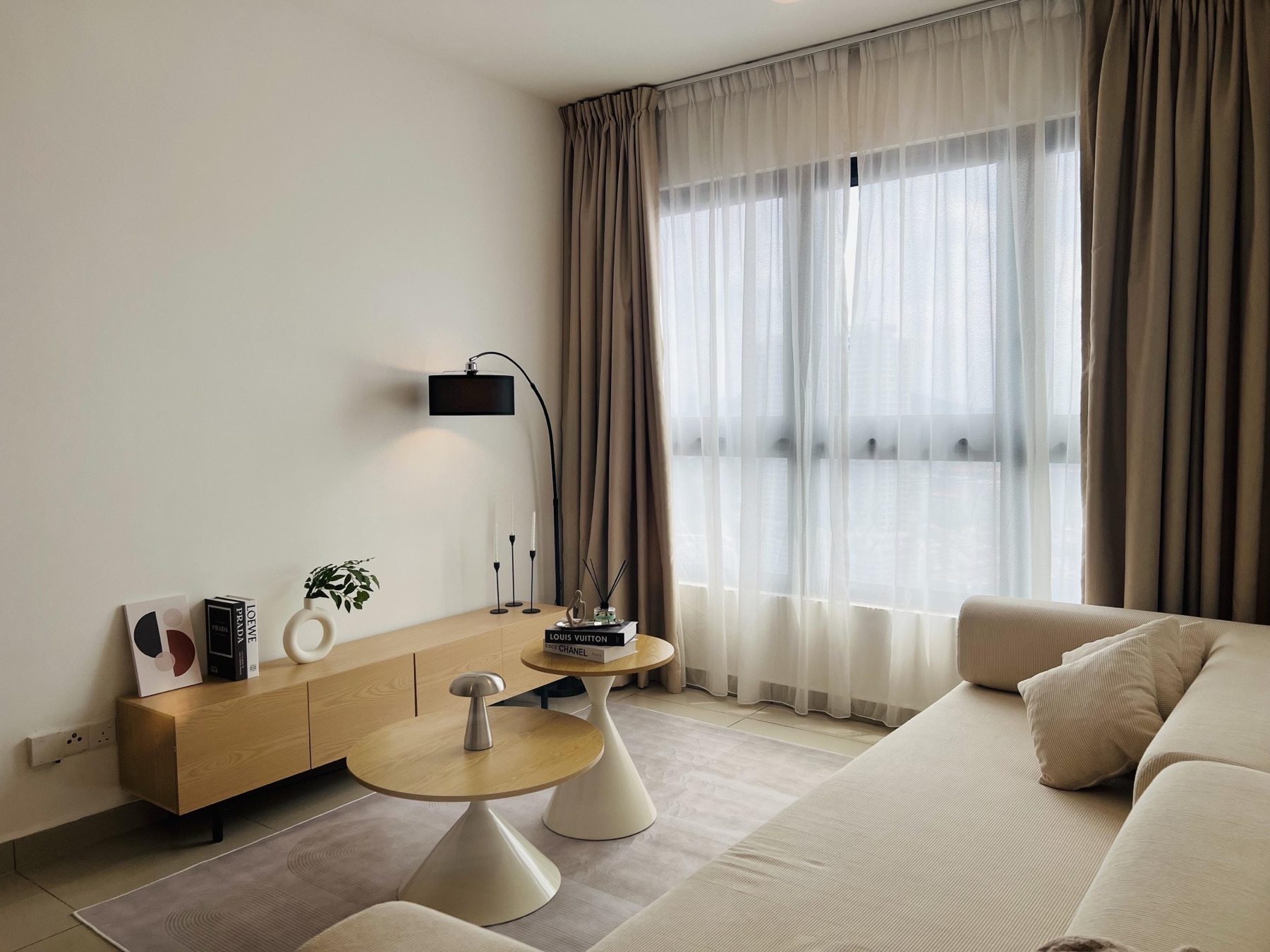 Living room detail with arc floor lamp and styled oak console